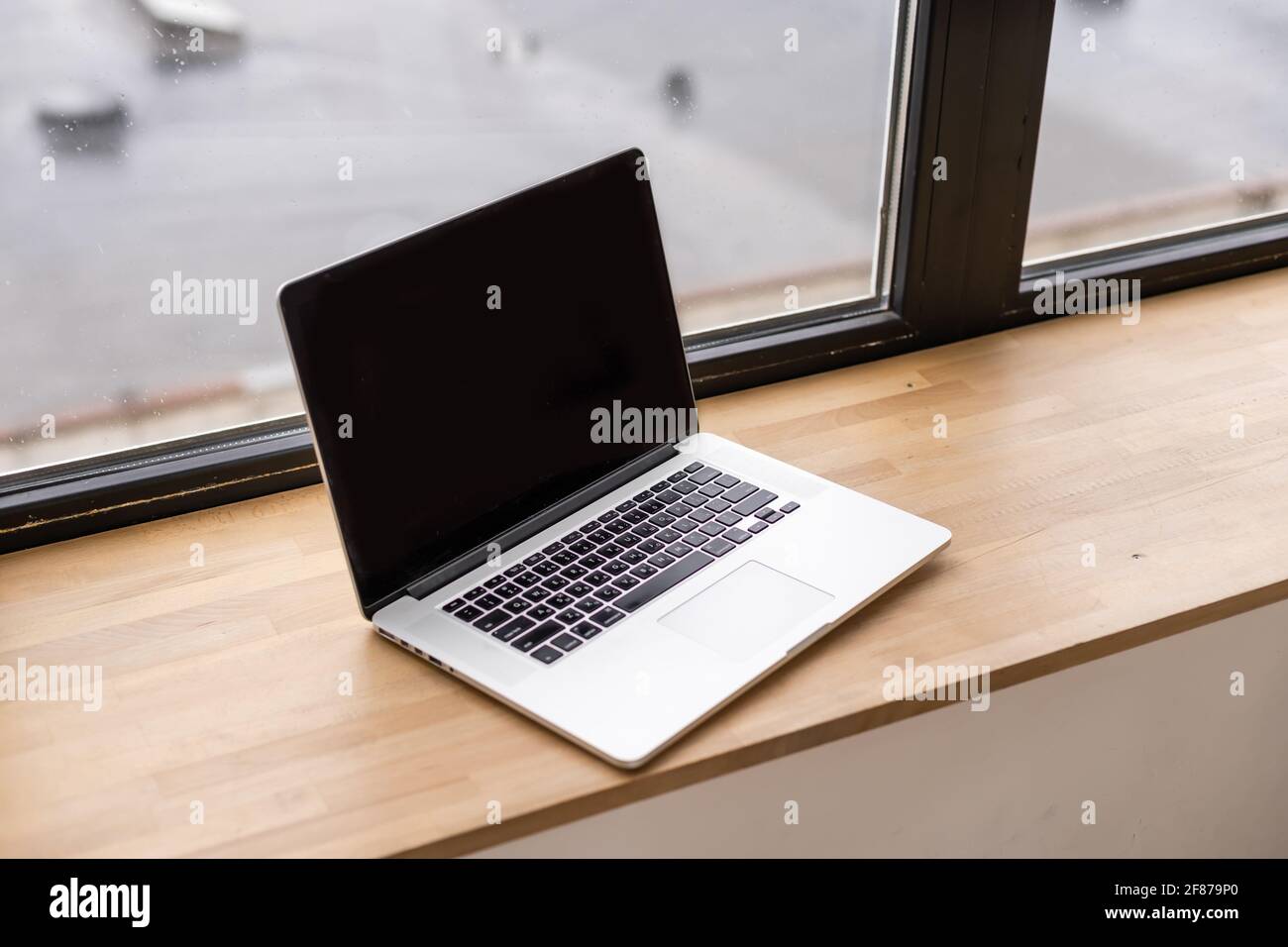 Laptop with blank screen on table Stock Photo