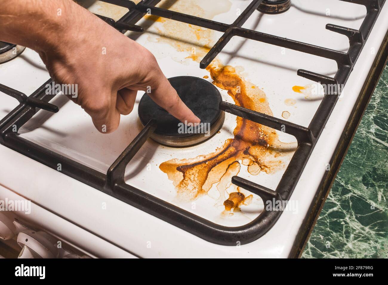 https://c8.alamy.com/comp/2F879RG/the-guys-hand-points-a-finger-at-the-dirty-plaque-on-the-gas-stove-after-home-cooking-in-the-kitchen-close-up-2F879RG.jpg