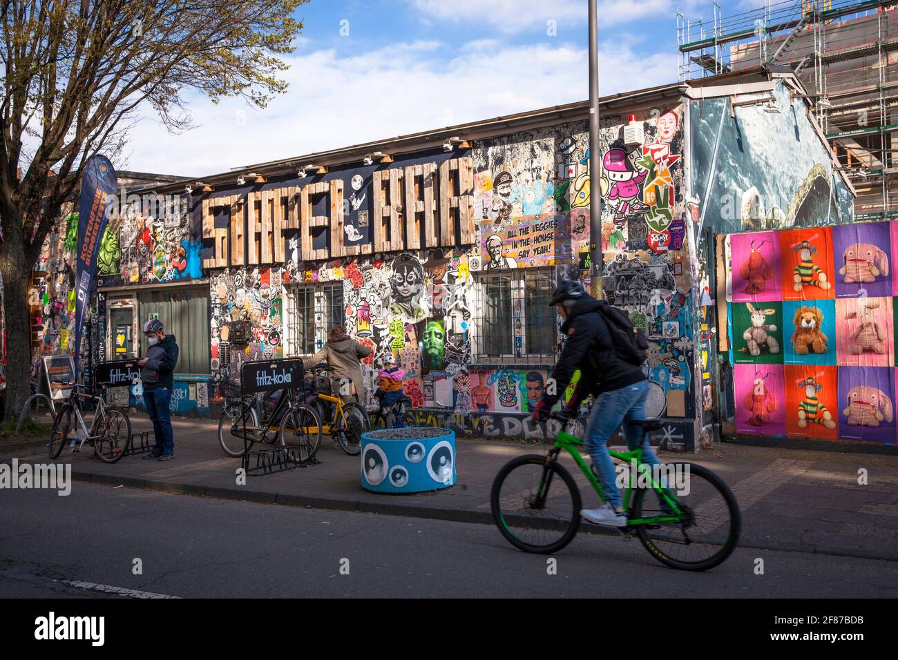 the cocktail bar Stapelbar (spelling: Stapel.Bar) on Helios street in the Ehrenfeld district, paste-ups and graffitis on the facade, Cologne, Germany. Stock Photo