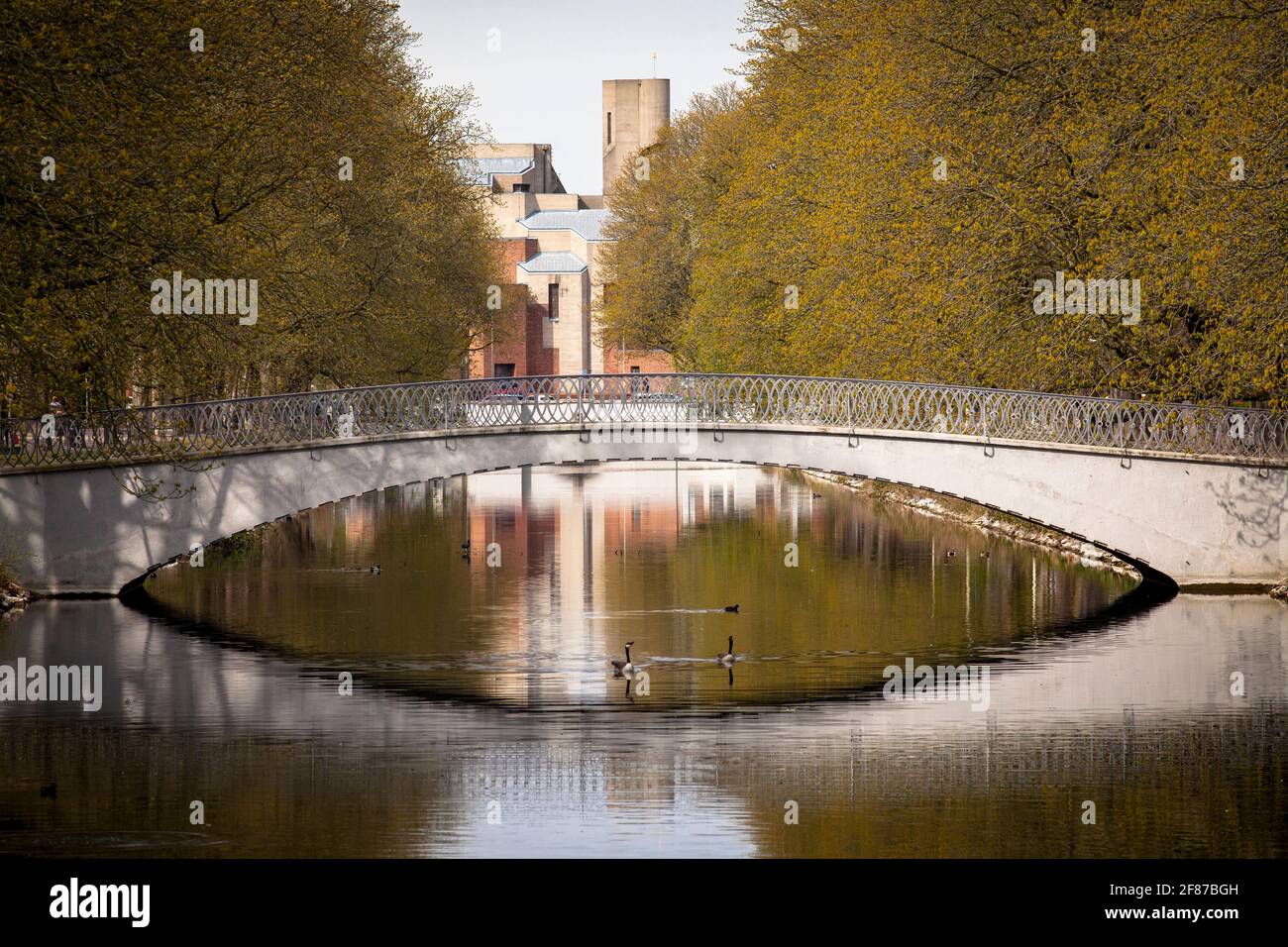 bridge across the Clarenbach canal in the district Lindenthal,  in the background the church Christi Auferstehung by architect Gottfried Boehm, Cologn Stock Photo