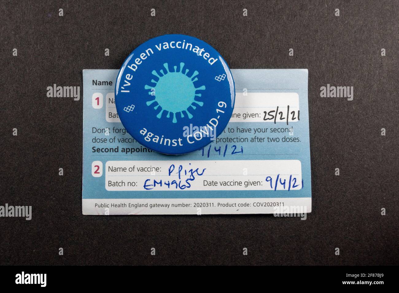 'I've been vaccinated against COVID-19' badge on a completed vaccination card during the Coronavirus pandemic (2021). Stock Photo