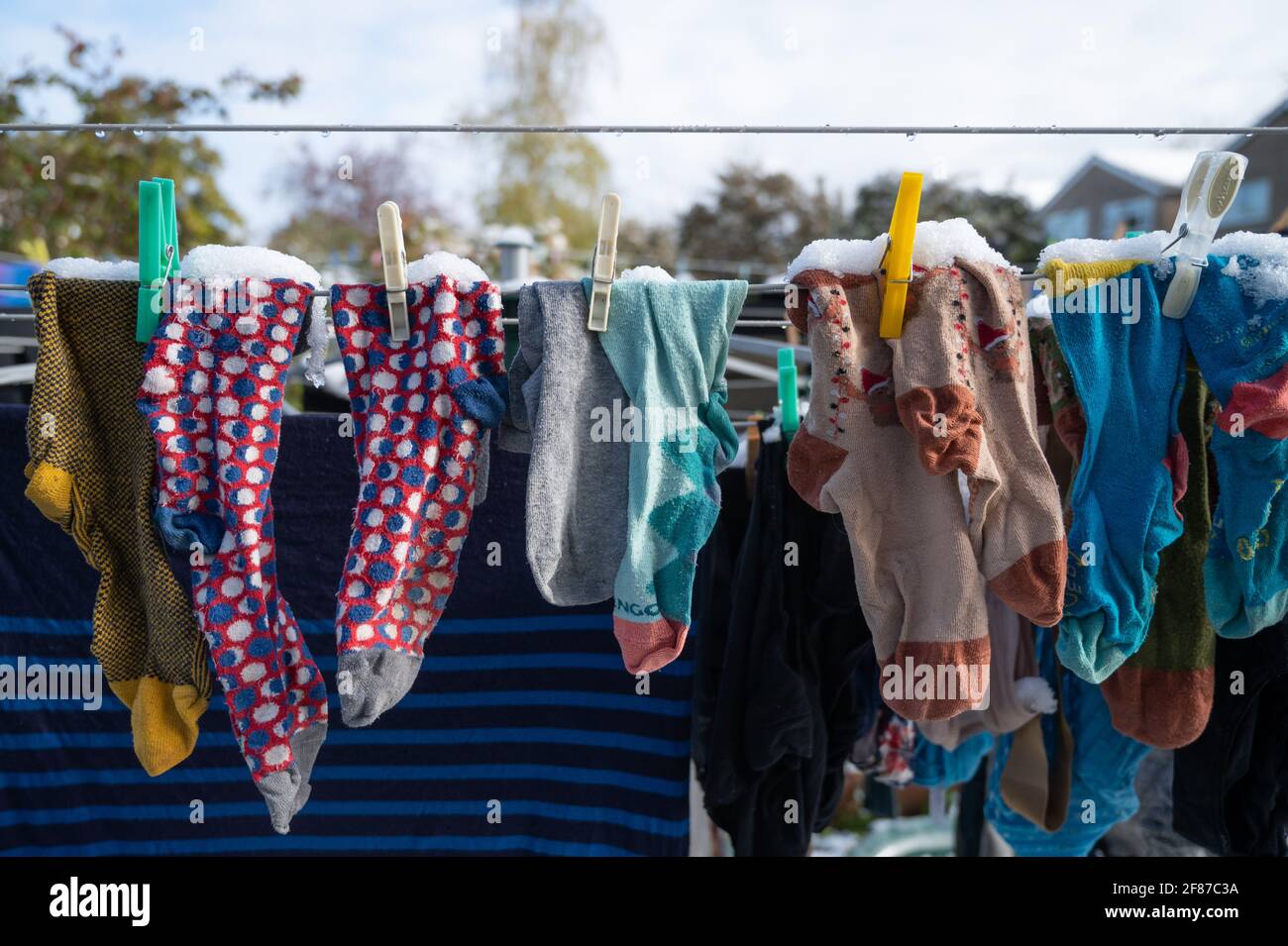 April 12th 2021. Oxford, UK. UK weather - Unseasonal snowfall covers laundry that has been hung outside to dry. Credit: Andrew Walmsley/Alamy Live News Stock Photo