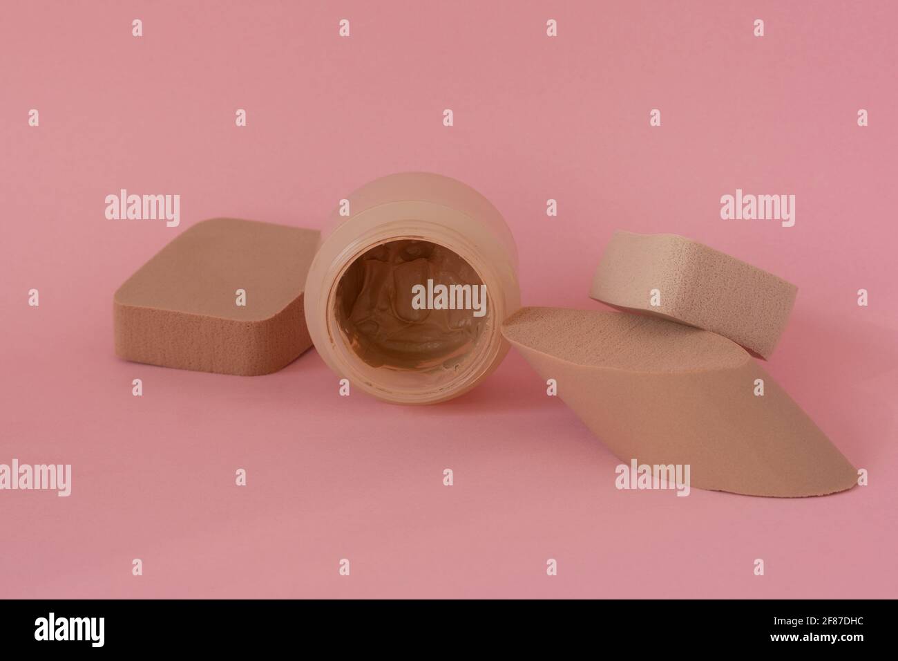 Powder makeup, sponges for applying face powder on pink background