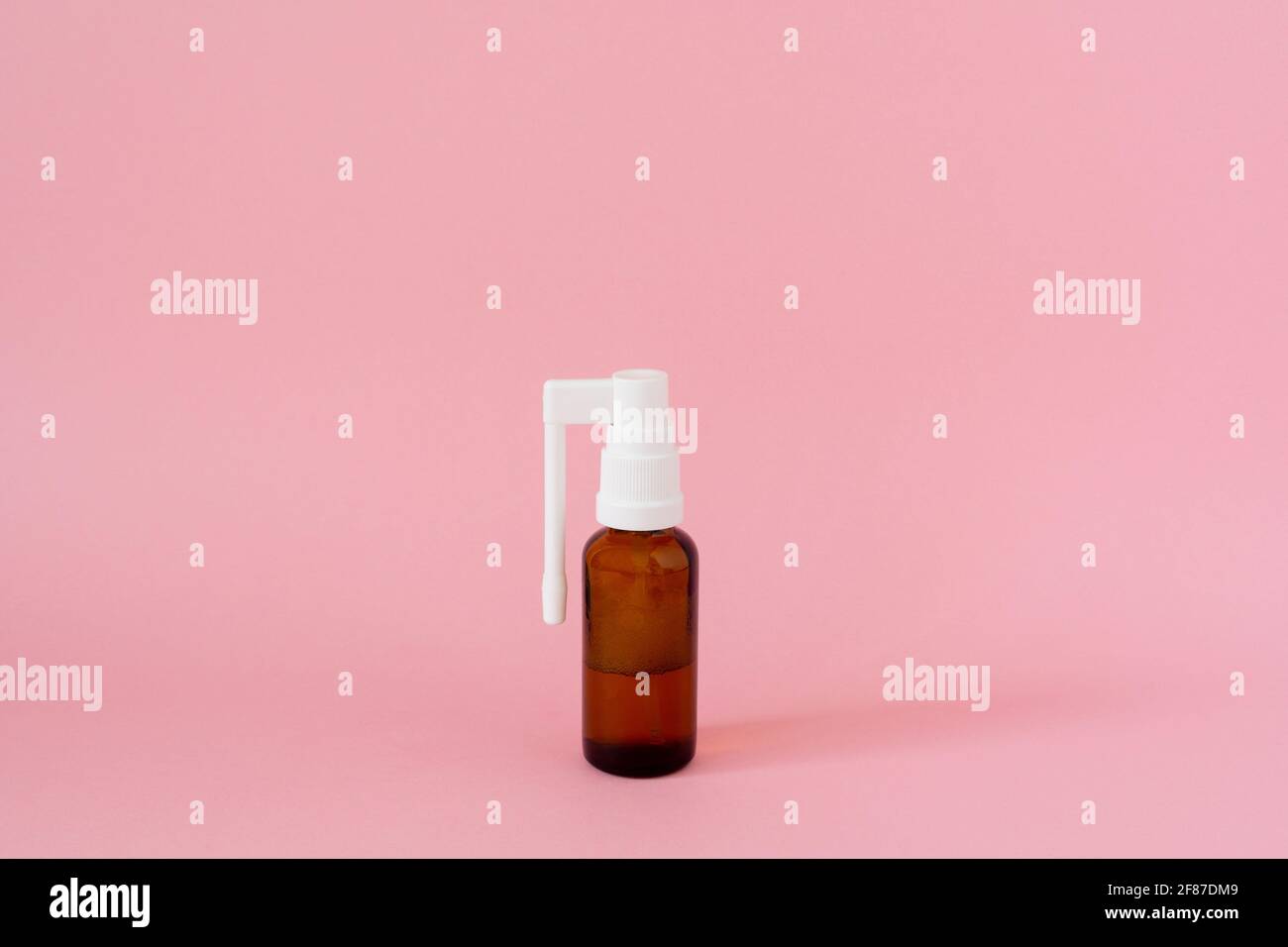 Throat spray medicine, oral or nasal medicines, on pink background Stock Photo