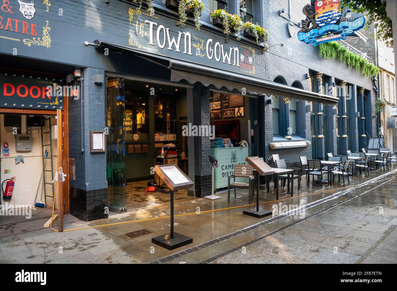 Cambridge, UK. 12th Apr, 2021. Staff clean the pavement and seating area outside the Town and Gown pub as hospitality venues reopen in Cambridge as part of the UK easing of Covid 19 lockdown restrictions. The roadmap allows outside service in pubs and bars from today. Credit: Julian Eales/Alamy Live News Stock Photo