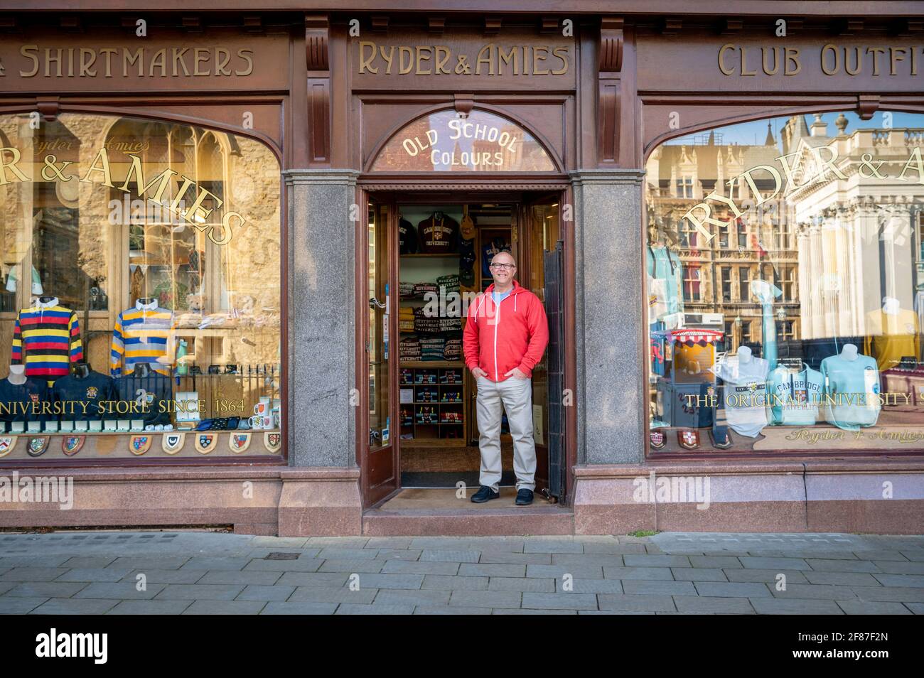 Cambridge, UK. 12th Apr, 2021. The owner of Ryder and Amies a family run specialist University clothing store opens his doors to the public as shops reopen in Cambridge as part of the UK easing of Covid 19 lockdown restrictions. The roadmap allows opening of non essential shops across England today. It was a relatively quiet start to the morning as shoppers returned to high Street retail outlets. Credit: Julian Eales/Alamy Live News Stock Photo