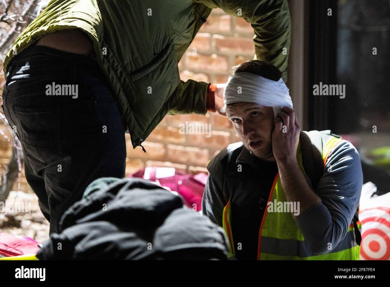 Brooklyn Center, Minnesota, April 11, 2021, A protestor is treated for