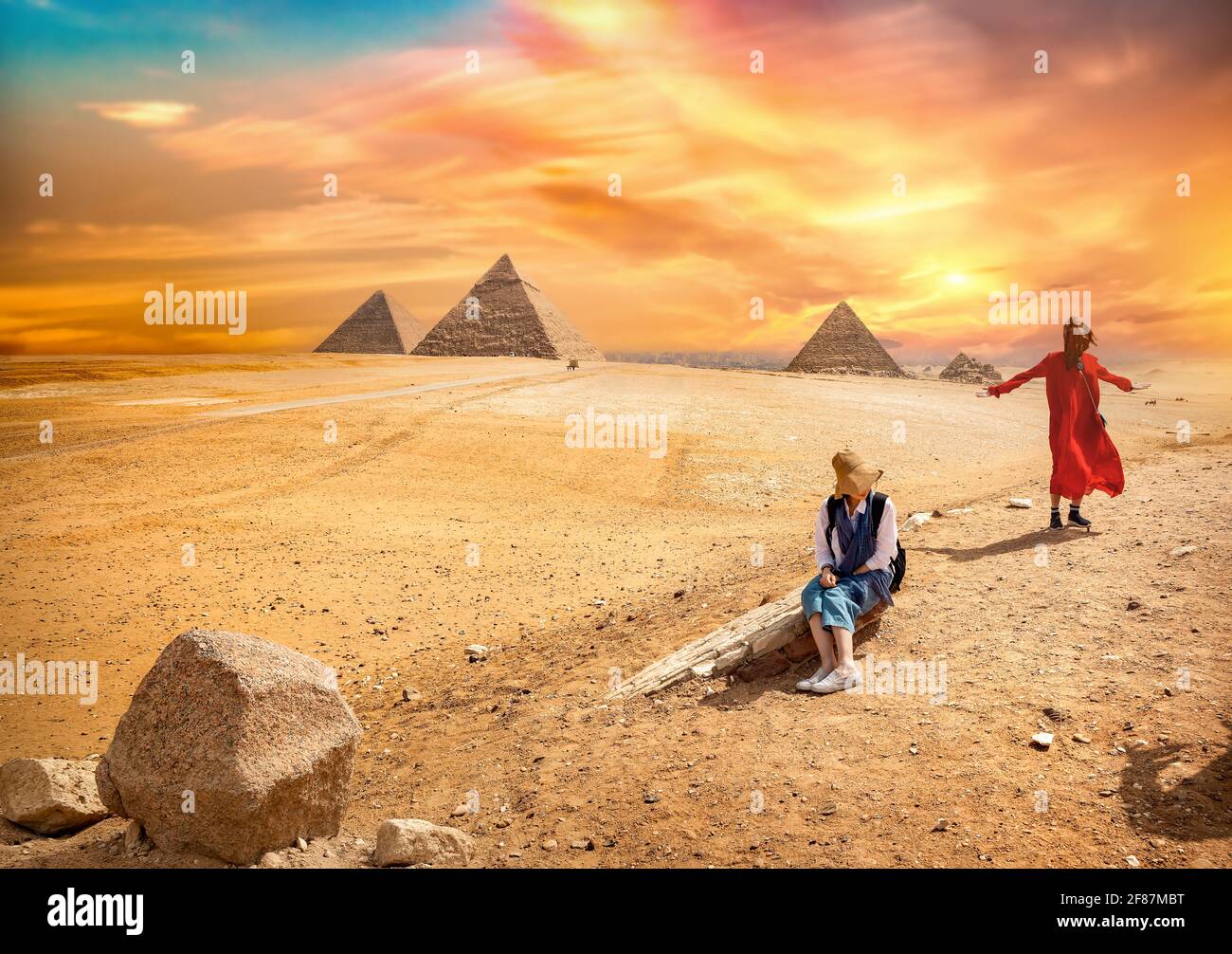 Tour near the egyptian pyramids at colorful sunset Stock Photo