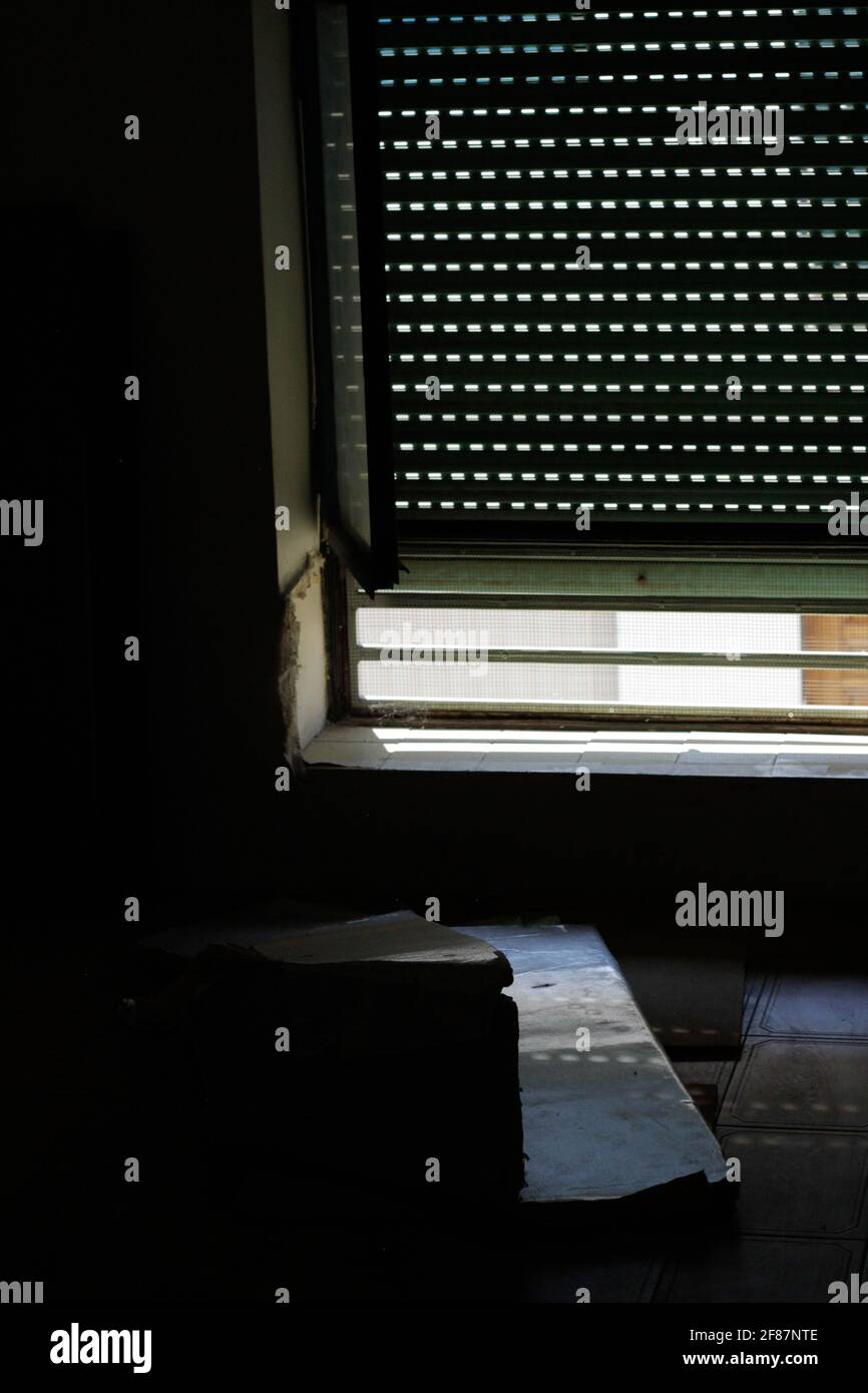 Shutters and boxes in an abandoned house Stock Photo