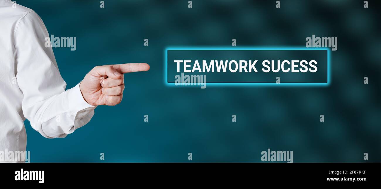 Male hand points to the word teamwork success. Business teamwork concept. Stock Photo