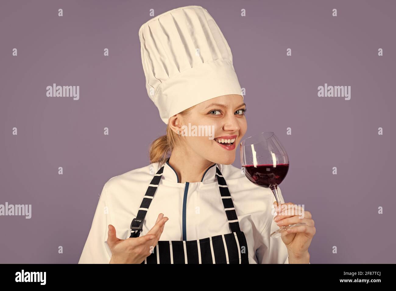 sweet and soft. sommelier with red cabernet or merlot. Restaurant beverage concept. cook degusting wine. woman hold wineglass in restaurant. perfect Stock Photo