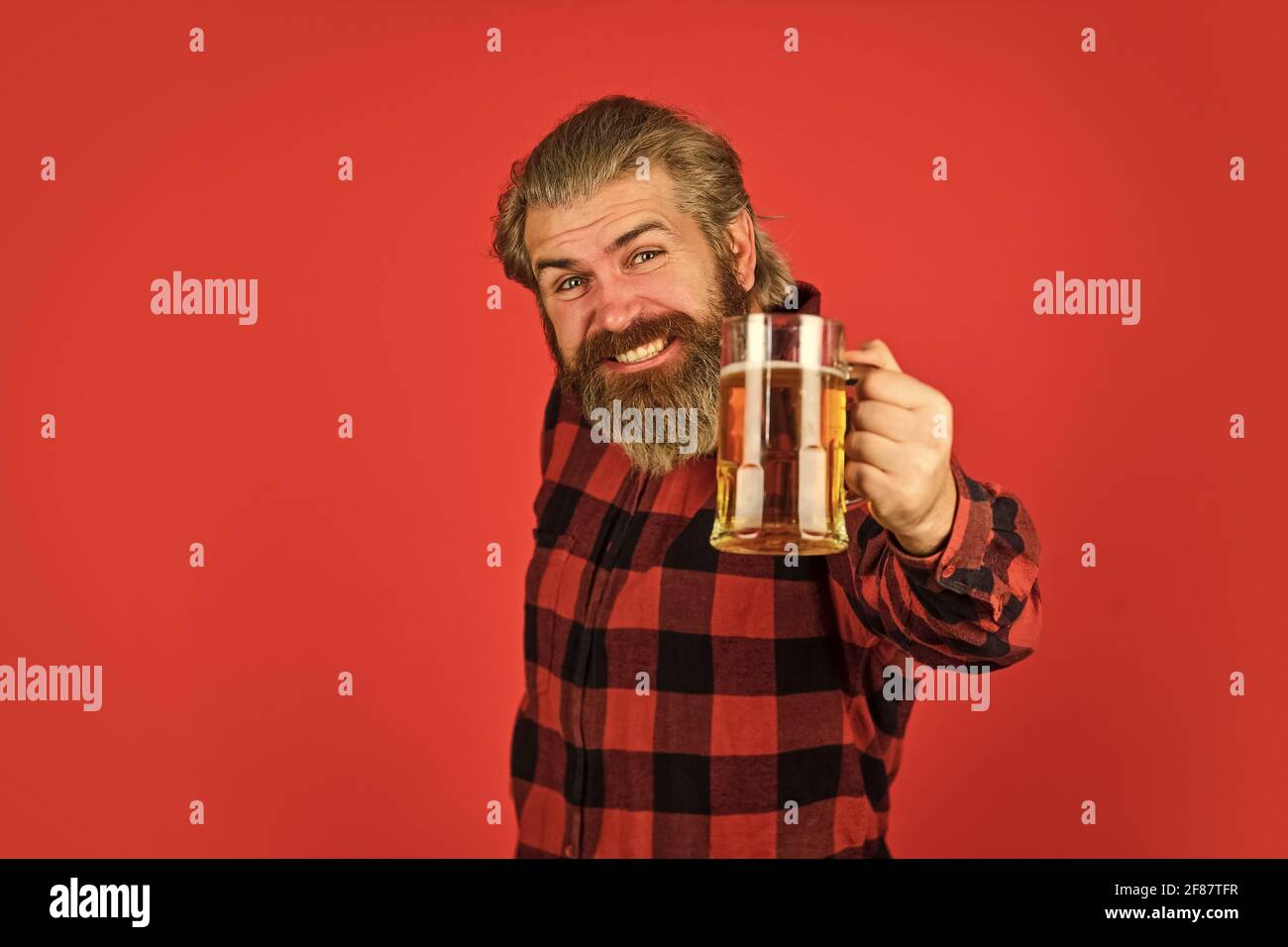 Beer festival. recreation. Man hold glass of beer. hipster at bar counter. having fun watching football. Brutal bearded male drinks beer from glass Stock Photo