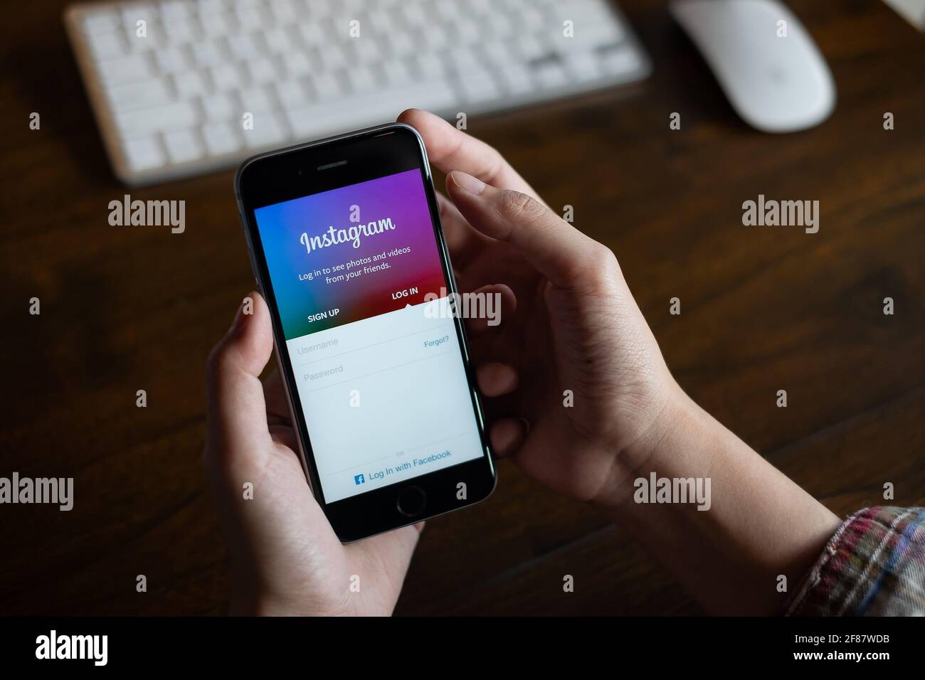 CHIANG MAI, THAILAND - FEB 26, 2020: A woman hand holding iphone with login screen of instagram application. Instagram is largest and most popular Stock Photo