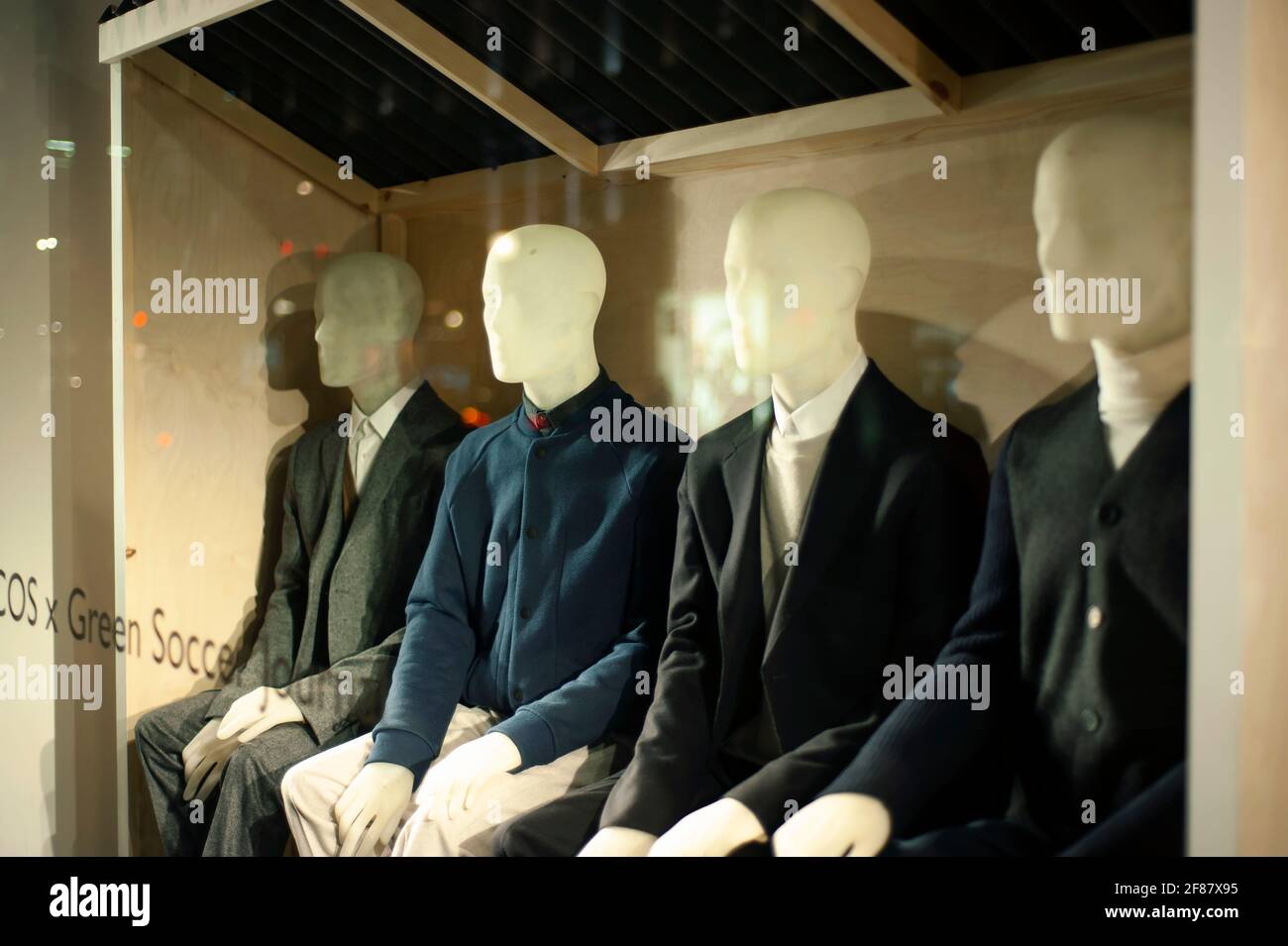 Male mannequins in fine retail shop window, shot at night. Smart wear trends in Central London, UK. Sep 2012 Stock Photo