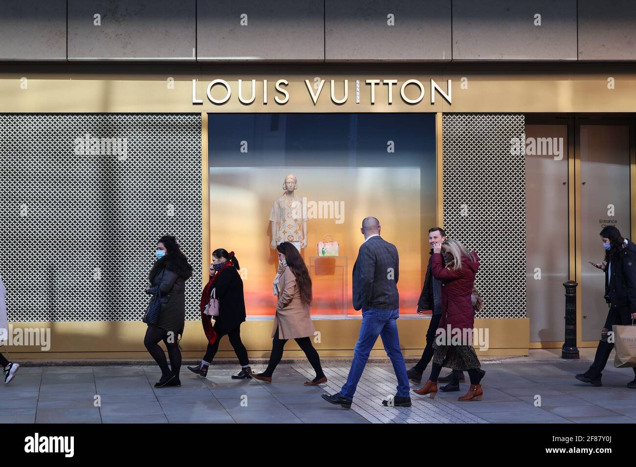 MANCHESTER, UK. April 12 2021: Long queues of people outside Louis Vuitton in as lockdown restrictions are lifted in Manchester city on Monday 12th April (Credit: Pat Scaasi