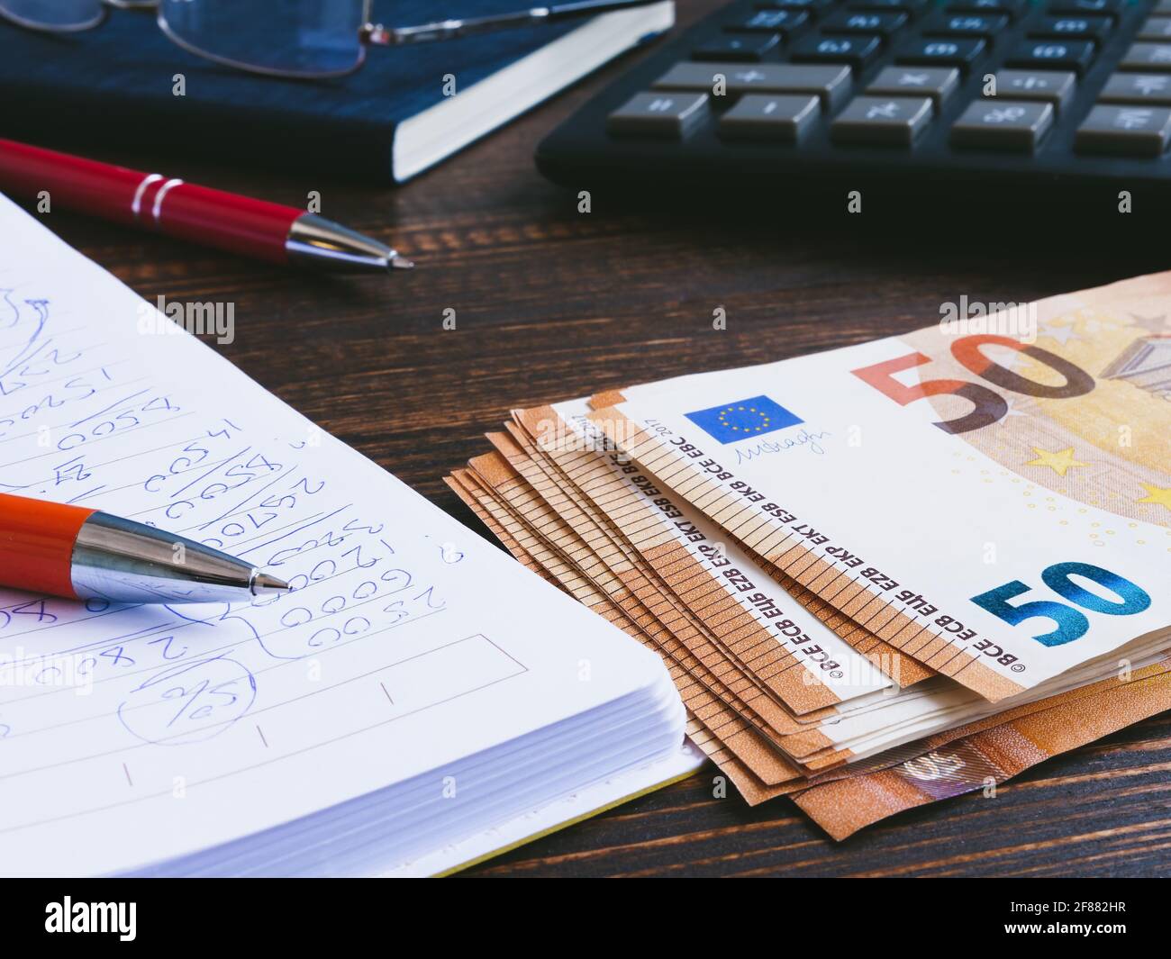 Home finance calculations and euro banknotes on the table. Stock Photo