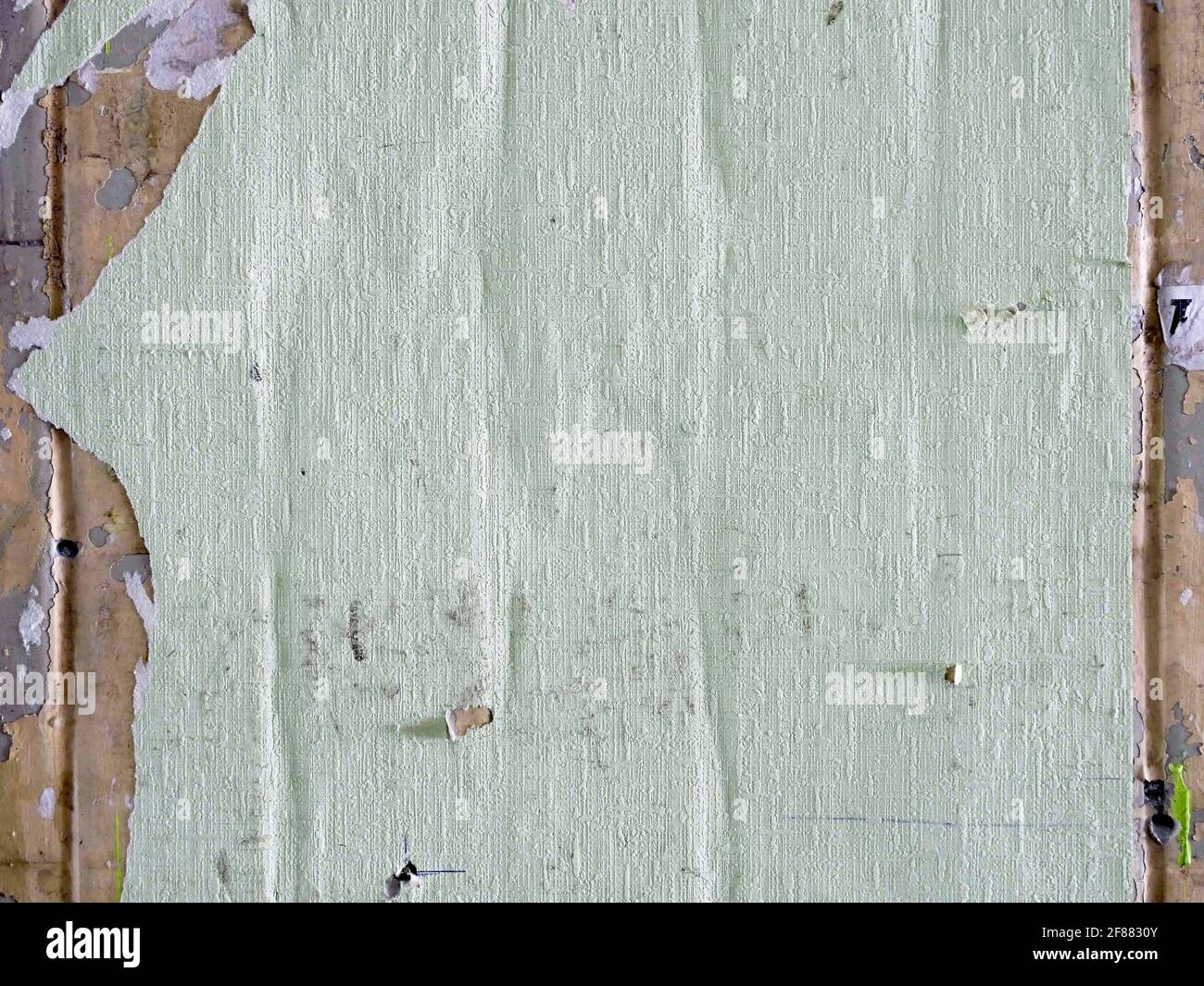 Creased crumpled placard with empty space on the wall. Grunge background. Stock Photo