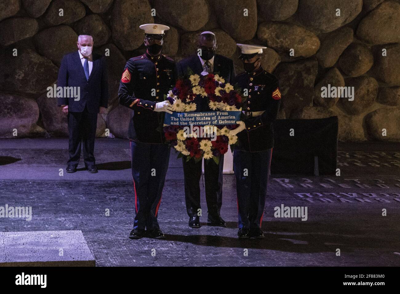 Jerusalem, Israel. 12th Apr, 2021. U.S. Secretary of Defense General Lloyd Austin carries a wreath together with U.S. Marines during a memorial ceremony in the Hall of Remembrance during his visit to Yad Vashem on Monday, April 12, 2021. Pool Photo by Heidi Levine/UPI Credit: UPI/Alamy Live News Stock Photo