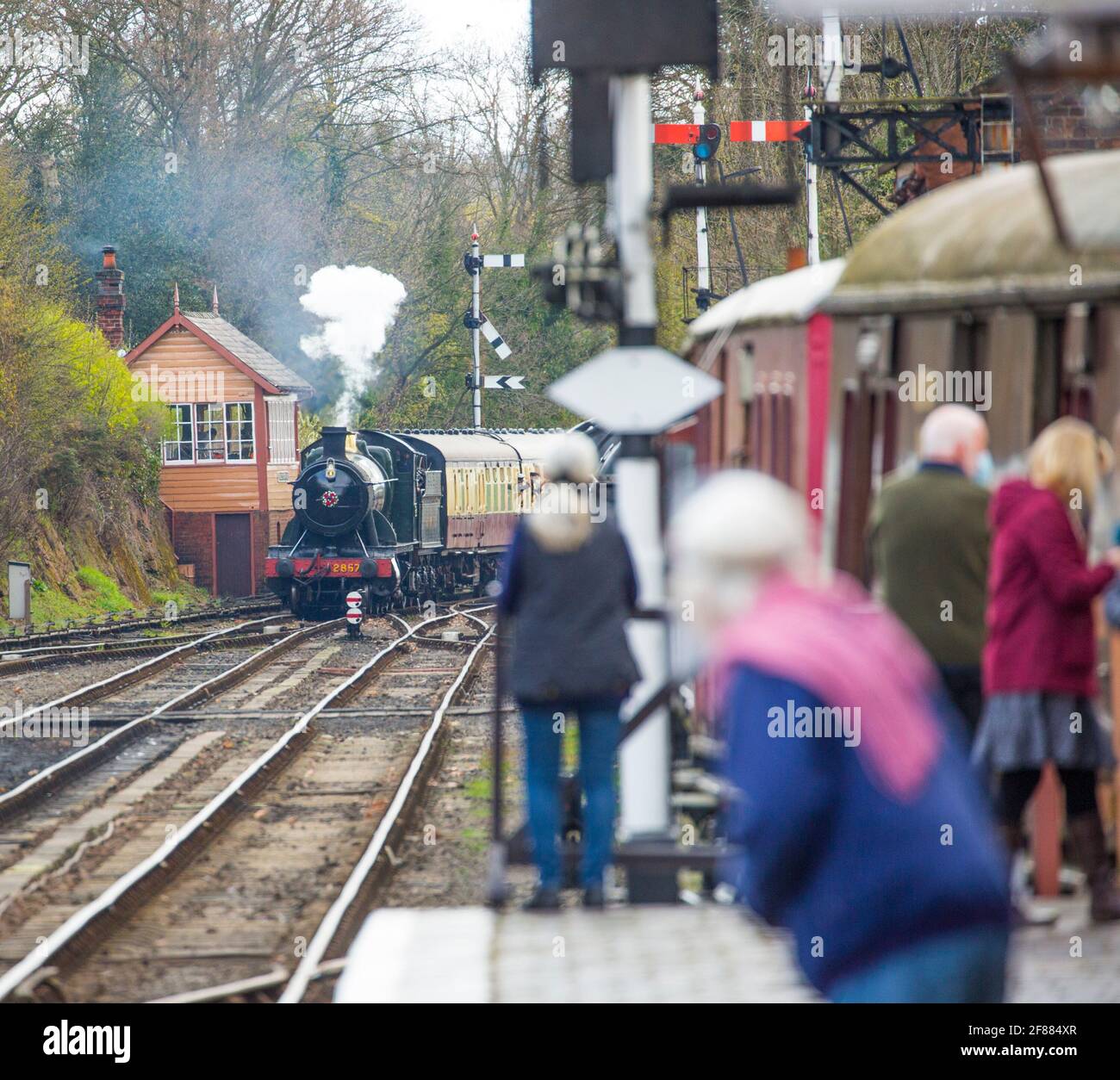 Bewdley, UK. 12th April, 2021. It's full steam ahead on the Severn Valley Railway as this heritage railway reopens following the easing of lockdown restrictions today. Vintage steam locomotive 2857 is seen here arriving at Bewdley station pulling a packed train behind her, the cab crew absolutely delighted to be 'back on track', driving this magnificent engine who has already clocked up over 100 years of railway service. Credit: Lee Hudson/Alamy Live News Stock Photo