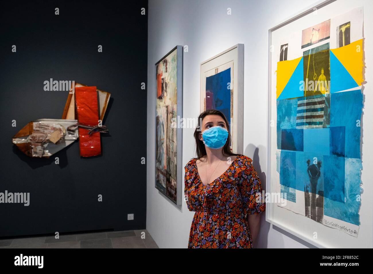 London, UK.  12 April 2021. A staff member poses with (R) 'Flue', 1980, by Robert Rauschenberg at the delayed opening of Robert Rauschenberg’s “Metal, Ink and Dye: Late Works from Captiva Island” exhibition at BASTIAN gallery in Mayfair.  The UK government’s coronavirus roadmap out of lockdown has allowed art galleries to reopen today. The exhibition runs 13 April to 8 May 2021. Credit: Stephen Chung / Alamy Live News Stock Photo