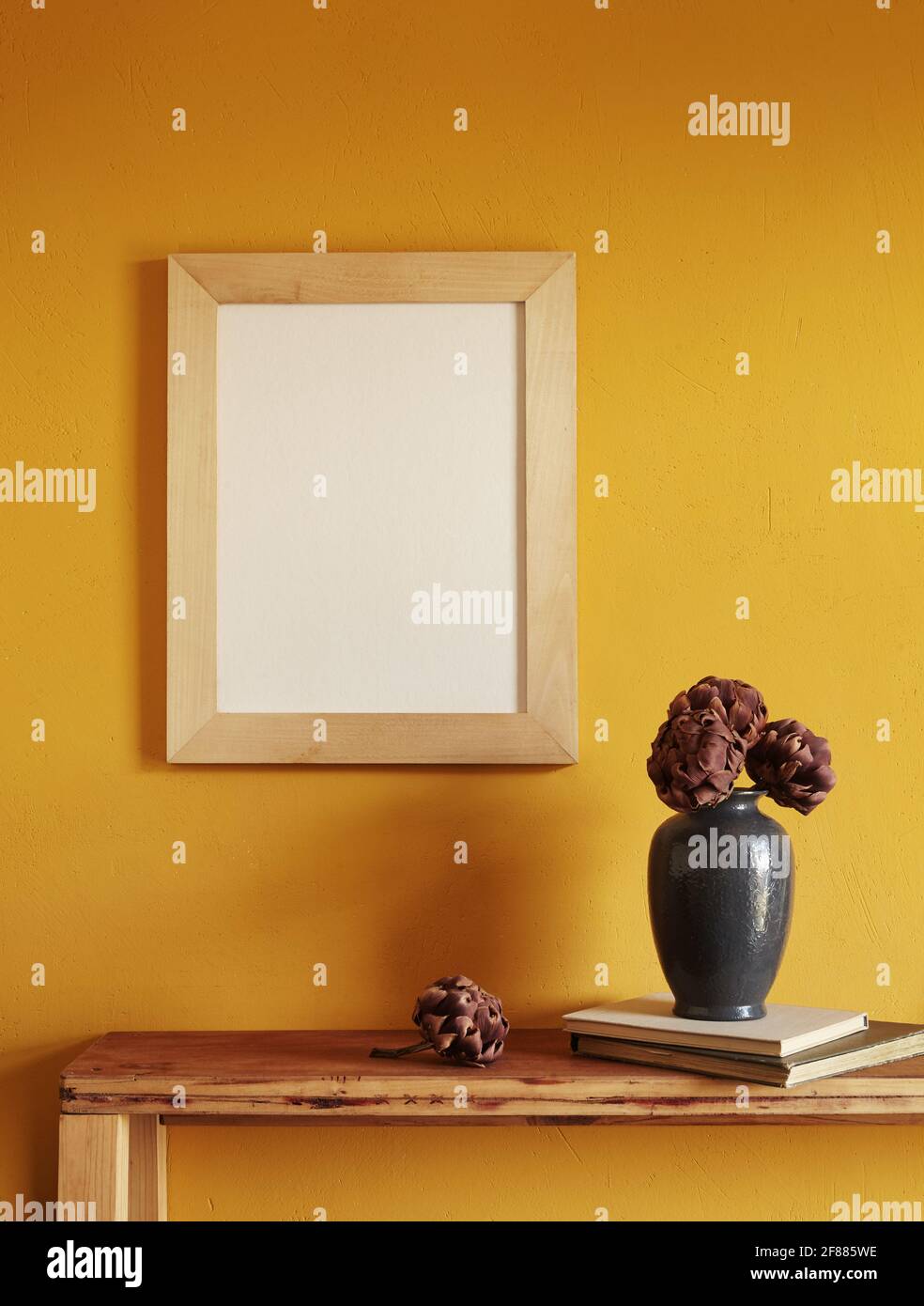 Wooden frames mockup. Dry decorative artichokes in a vase on an old