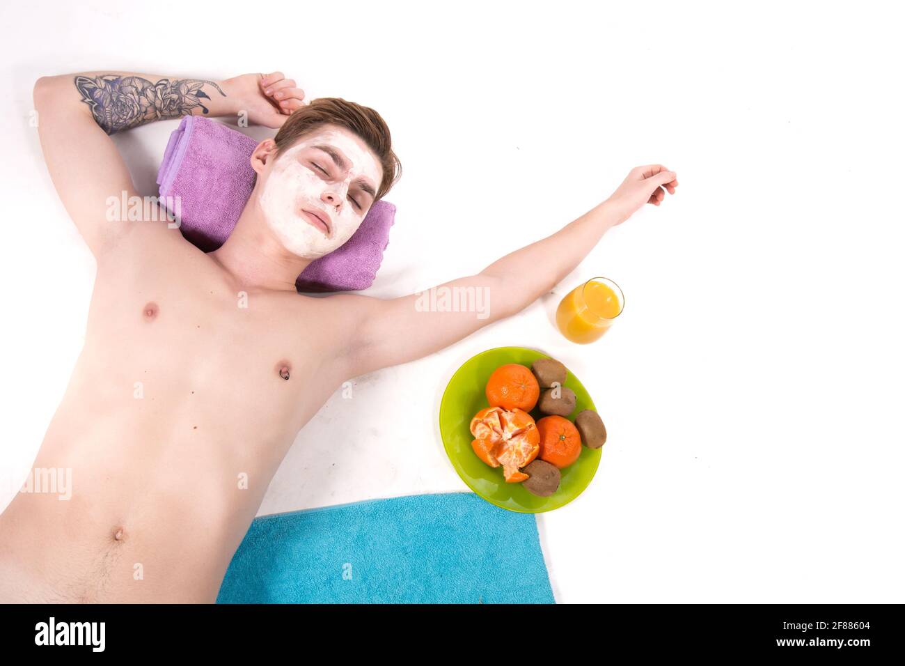 Male beauty. Attractive guy and spa. White background. Stock Photo