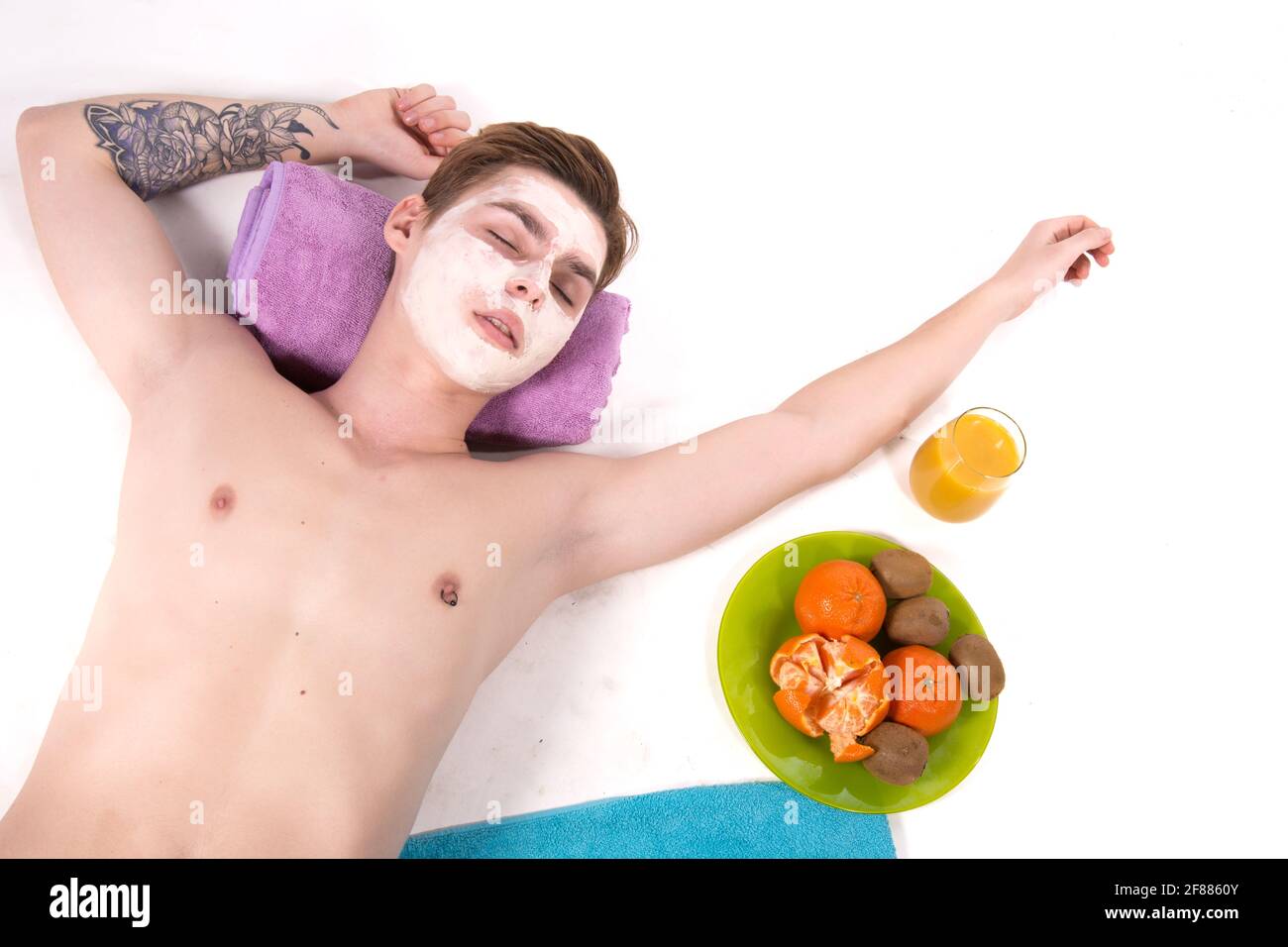Male beauty. Attractive guy and spa. White background. Stock Photo