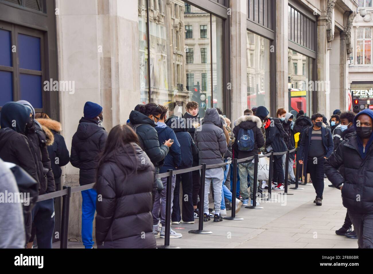London, United Kingdom. 12th April 2021. Customers queue outside the Nike  store on Oxford Circus. Shops, restaurants, bars and other businesses  reopened today after almost four months as further lockdown rules are