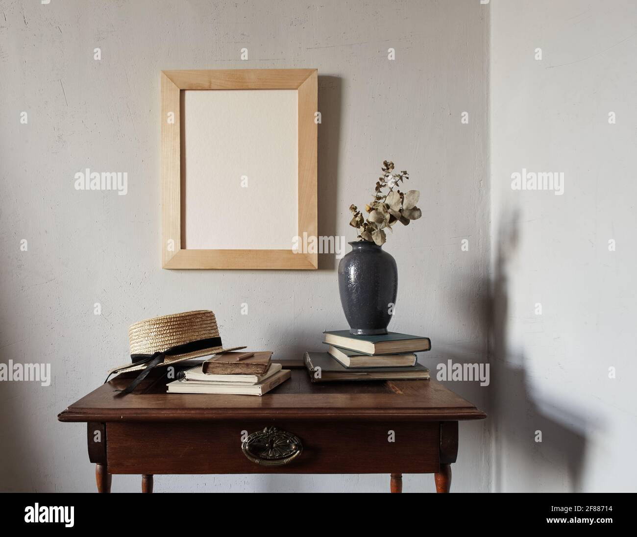 Wooden frame mockup. composition with notebook, books, vase with dried flowers on an old wooden table Stock Photo