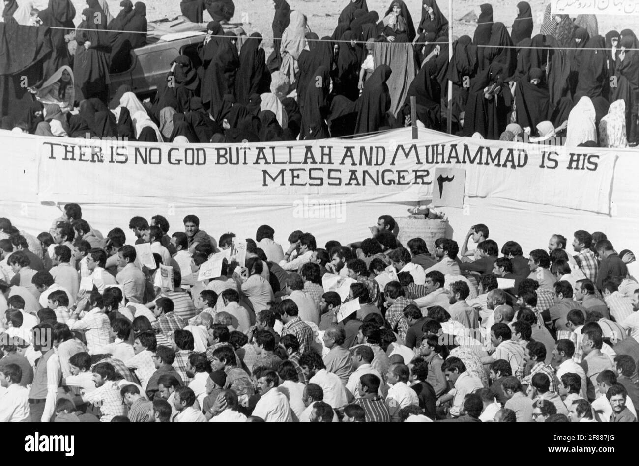 Women and children protesting against Shah Mohammad Reza Pahlavi in Teheran, Iran, September 06, 1978. The religious leaders in Iran have a strong grip on the masses. In the picture protesters in prayer under a banner with the Islamic creed in English, there is no god but Allah and Muhammad is his prophet.  Photo: Stig A Nilsson / DN / TT / code 43 Stock Photo
