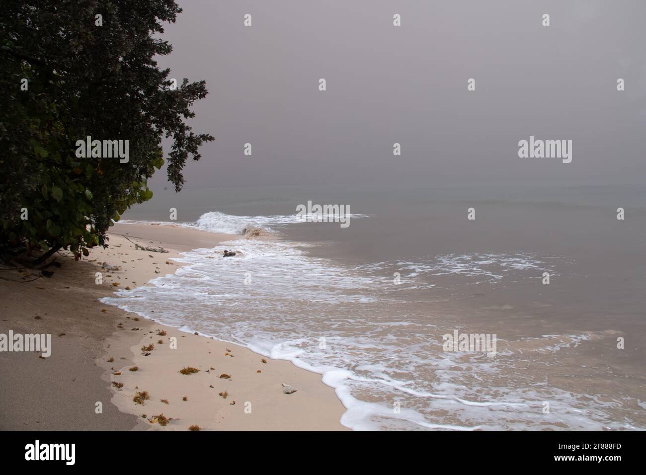 St. James, Barbados - April 10 2021: Thick ash from St. Vincent and Grenadine's Soufriere volcano eruption turns the sky and ocean grey in Barbados. Stock Photo