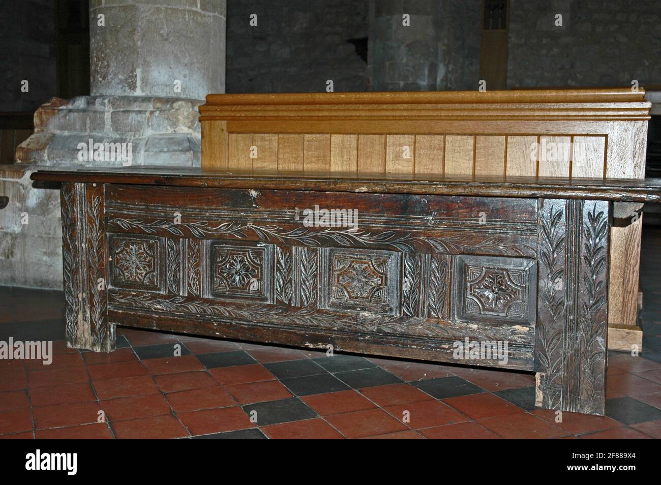 Early thirteenth century parish chest.  Carved from solid oak, an inch, or two centimetres thick.  Four staple lock.  Bolt runs whole length of one si Stock Photo