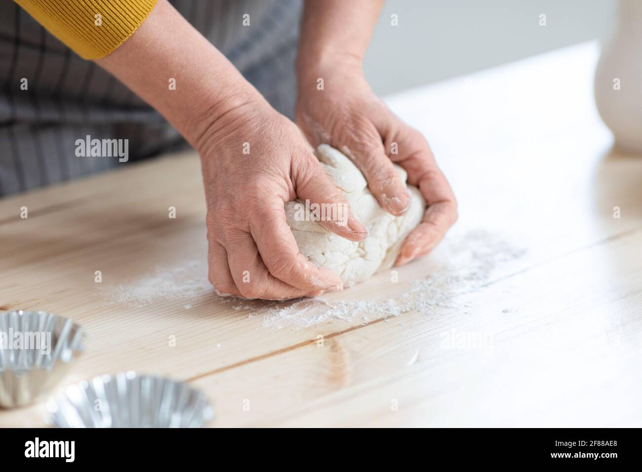 Female hands kneading dough, woman cooking in kitchen Stock Photo - Alamy