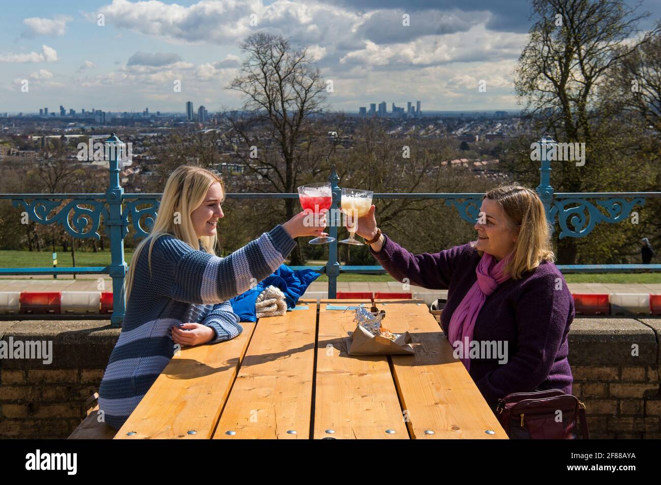 Customers enjoy a drink at the reopening of the Terrace Bar at Alexandra Palace, London, as England takes another step back towards normality with the further easing of lockdown restrictions. Picture date: Monday April 12, 2021. Stock Photo