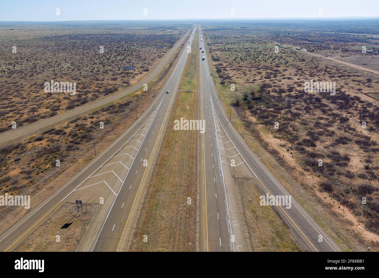 Aerial view of long road through desert landscape towards near San Jon
