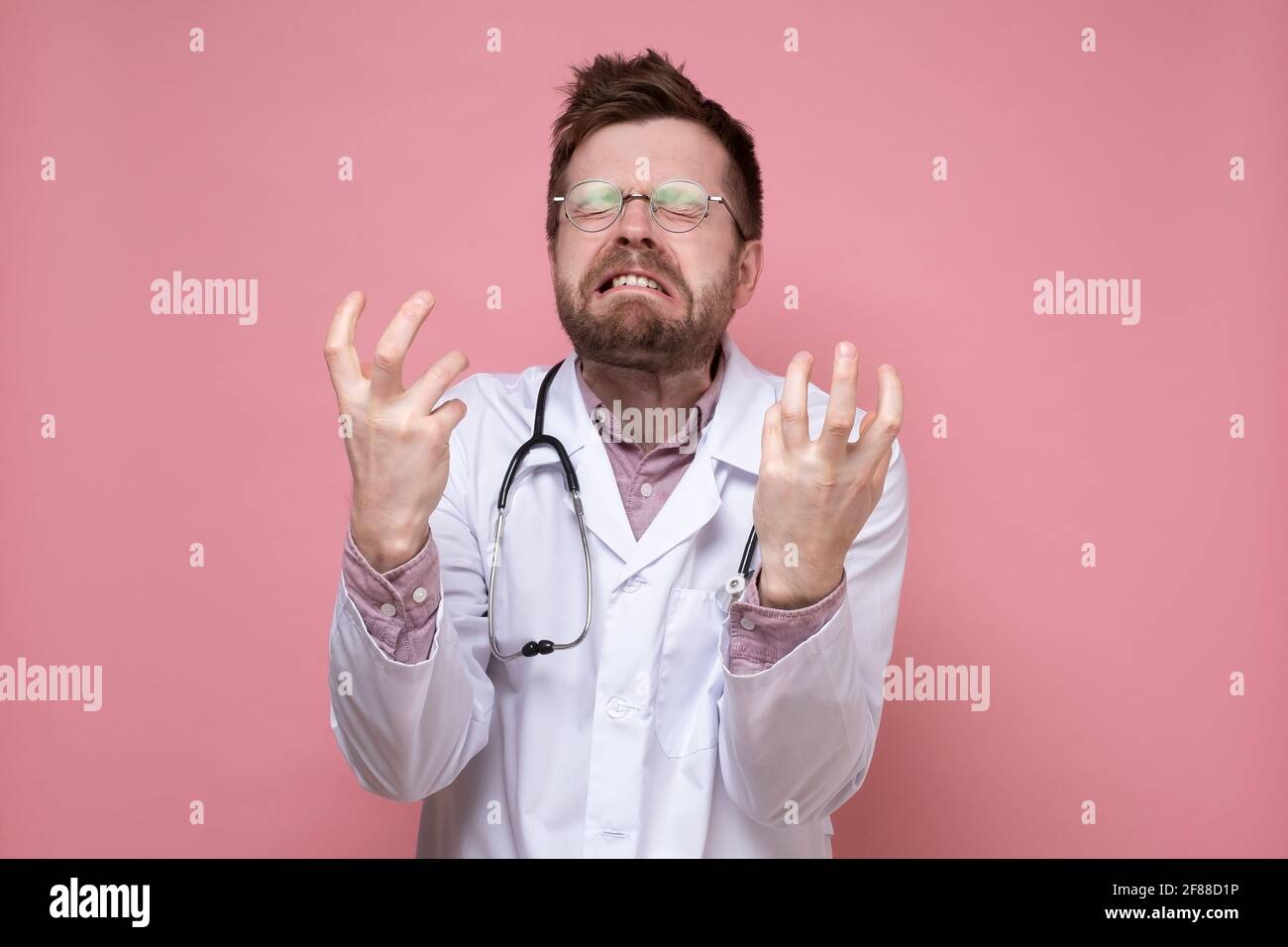 Doctor with a stethoscope around neck in stress, he bares teeth