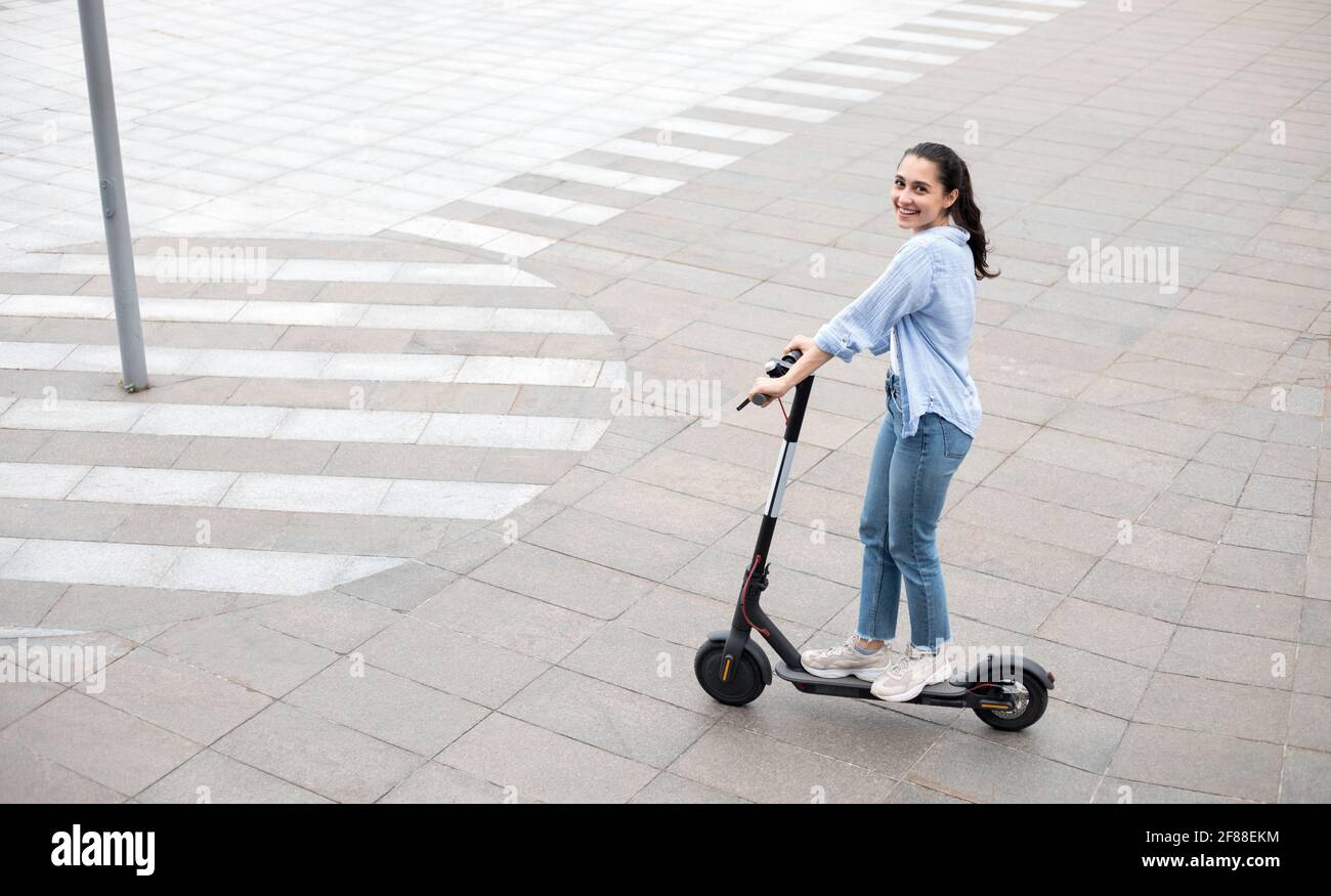 Lady on electric scooter hi-res stock photography and images - Alamy