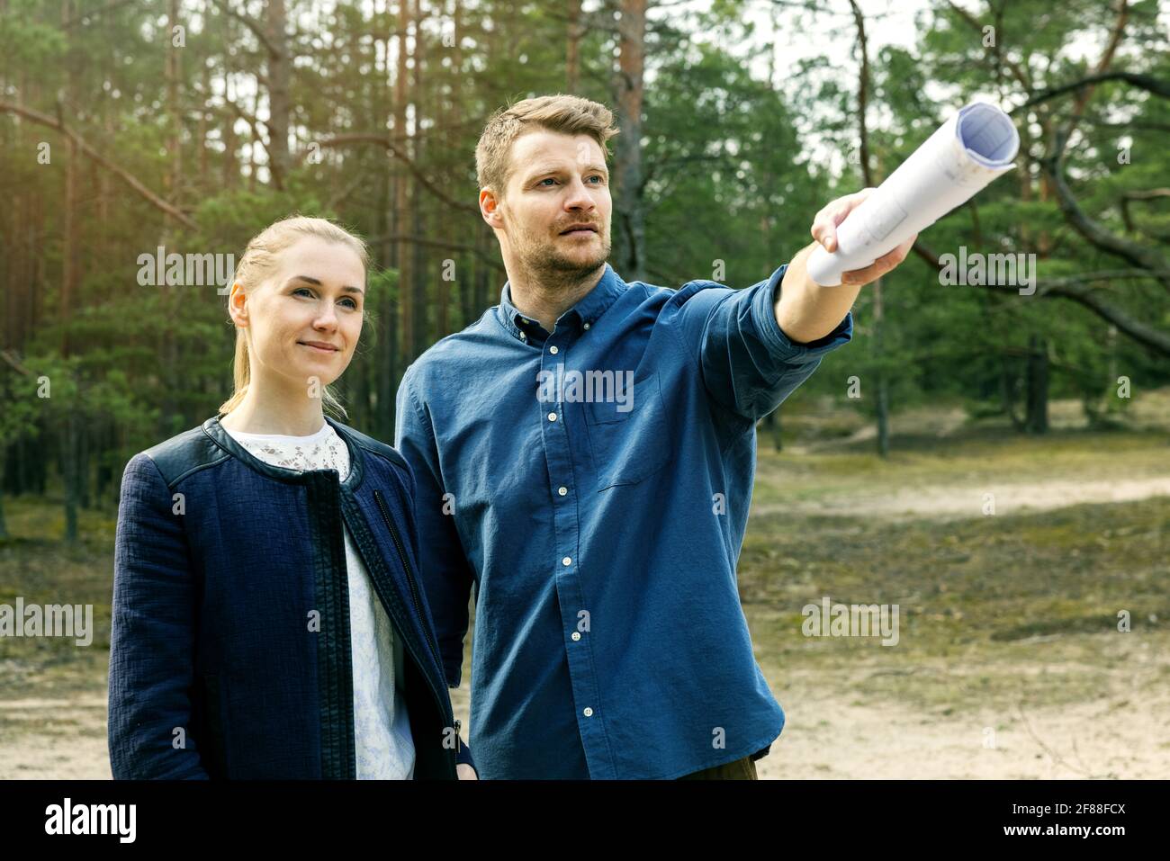 young couple viewing and choosing a plot of land for dream house construction Stock Photo
