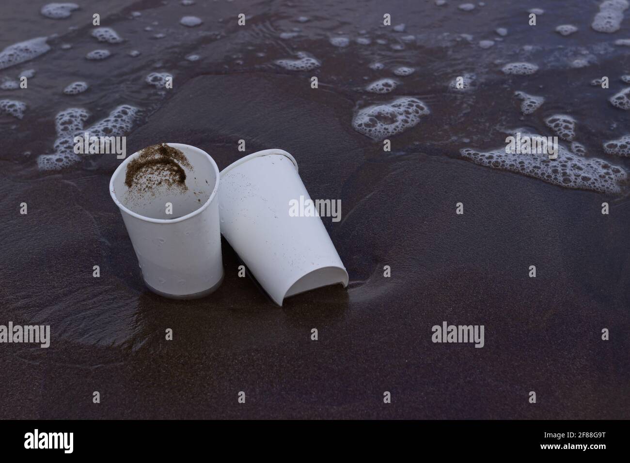 Two plastic cups on the sand Stock Photo Alamy