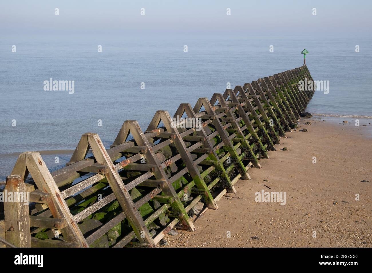 Large stone filled wooden groyne at on the beach at Walton on the Naze, Tendring, Essex, England, UK, Britain Stock Photo