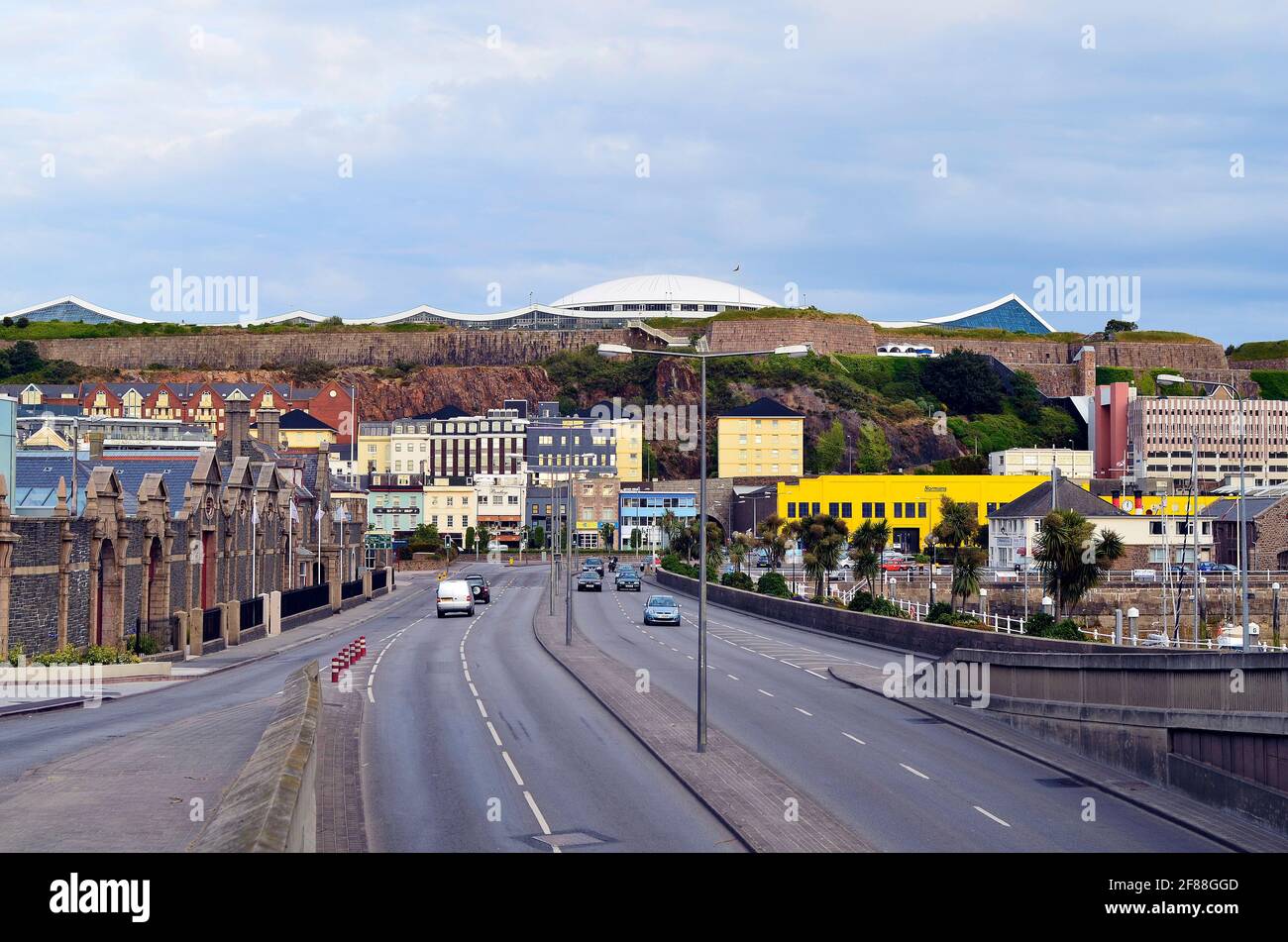 Jersey, UK - June 09, 2011: Street in St. Helier on the Channel Island with  maritime museum and Fort Regent leisure center on hill Stock Photo - Alamy