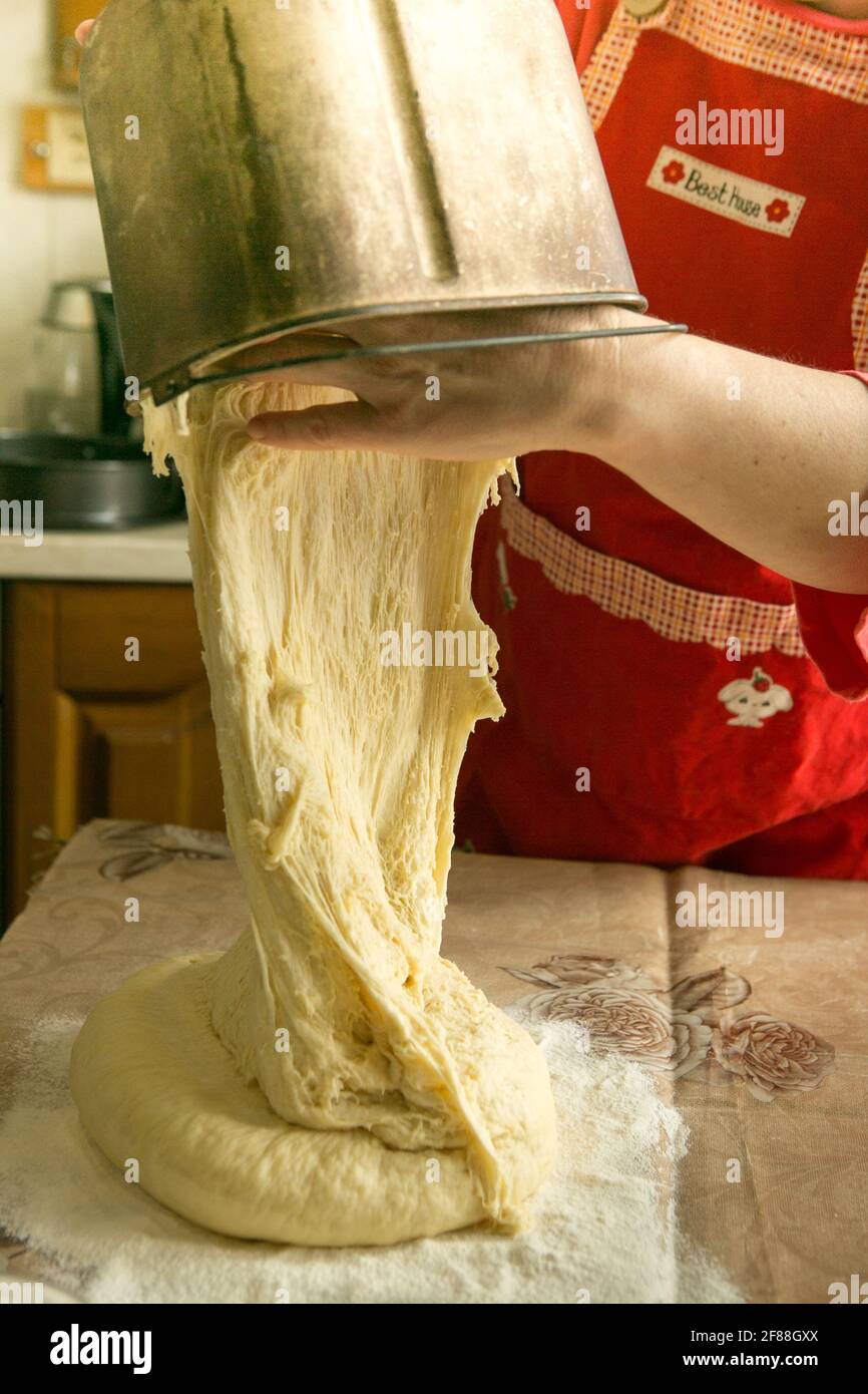 https://c8.alamy.com/comp/2F88GXX/moms-pies-female-hands-spread-the-dough-from-the-bread-machine-cooking-during-quarantine-2F88GXX.jpg