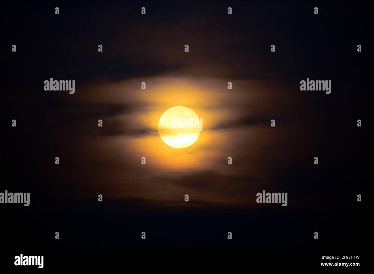full moon with veil of clouds Stock Photo