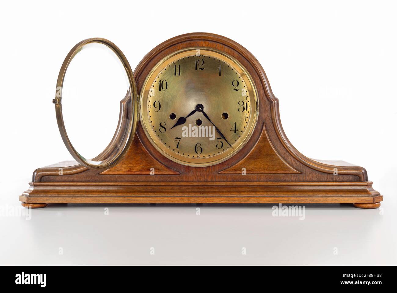 Antique wooden mantle clock against a white background Stock Photo Alamy