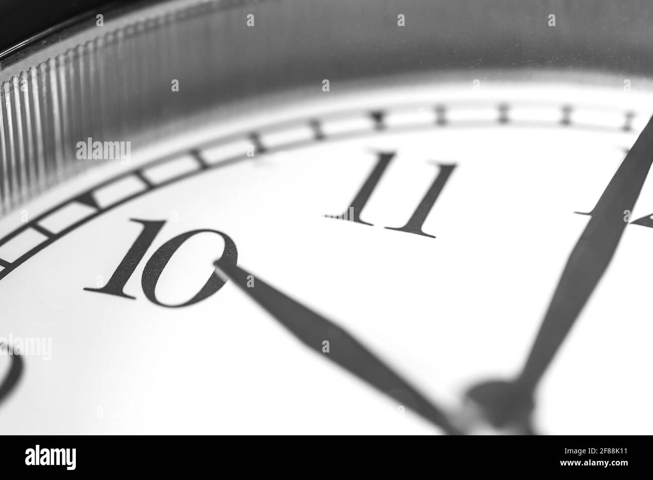 Clock hand pointing ten o'clock on white clock face of Twin bell