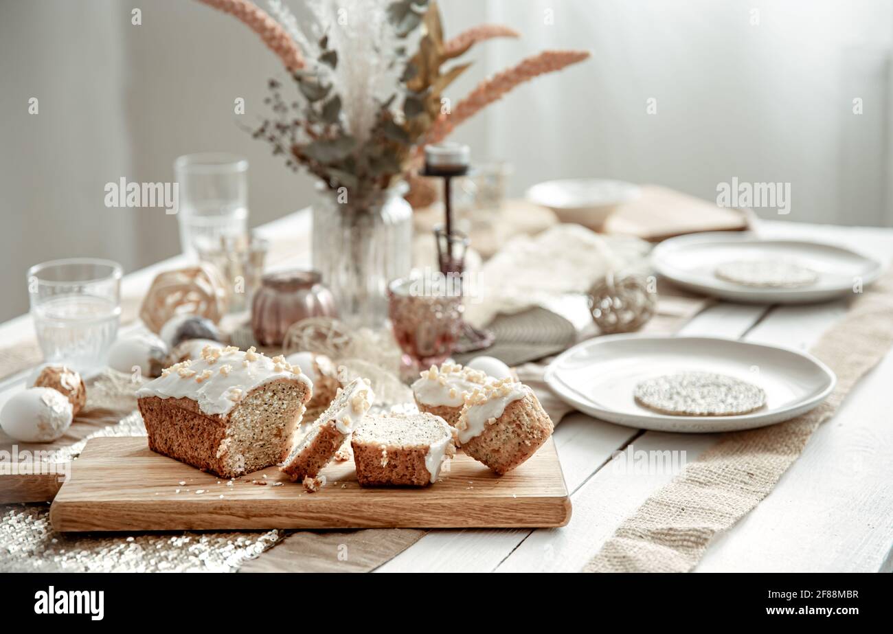 A festive table with a beautiful setting and freshly baked Easter cake. Stock Photo