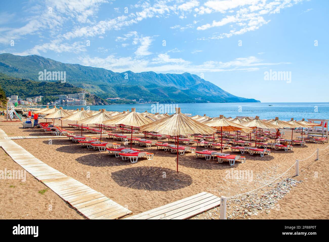 Becici beach in Montenegro , Sun umbrellas and loungers at the sandy beach  . Summer Adriatic seaside Stock Photo - Alamy