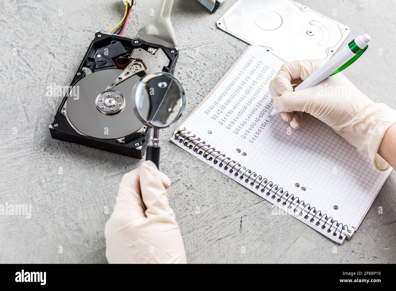 Concept of data recovery, engineer is recovering data from failed hard disk  driver. Hdd disk restoration, magnifier and binary code Stock Photo - Alamy