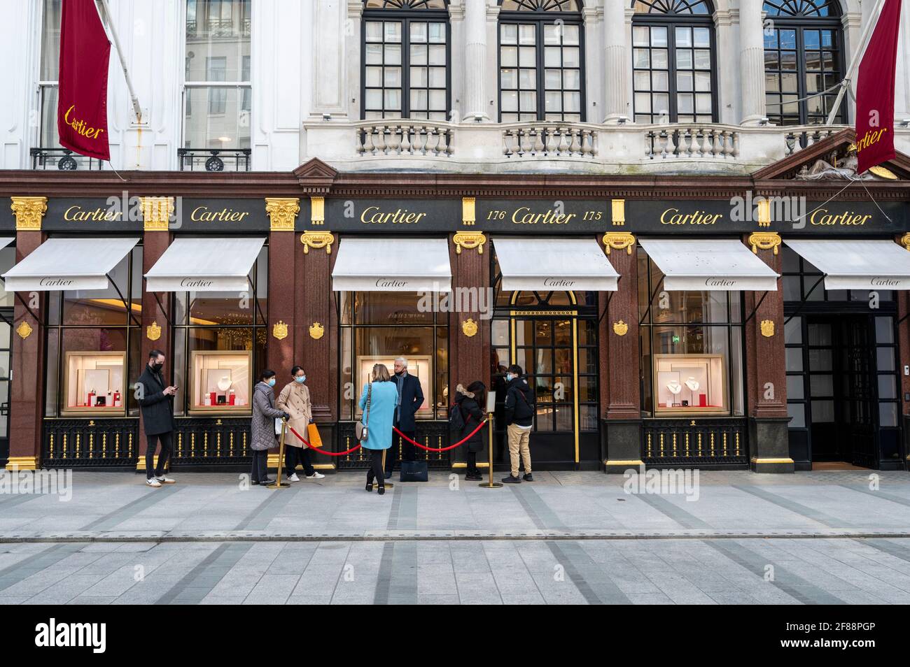 London, UK. 12 April 2021. People queue outside the Cartier store in ...