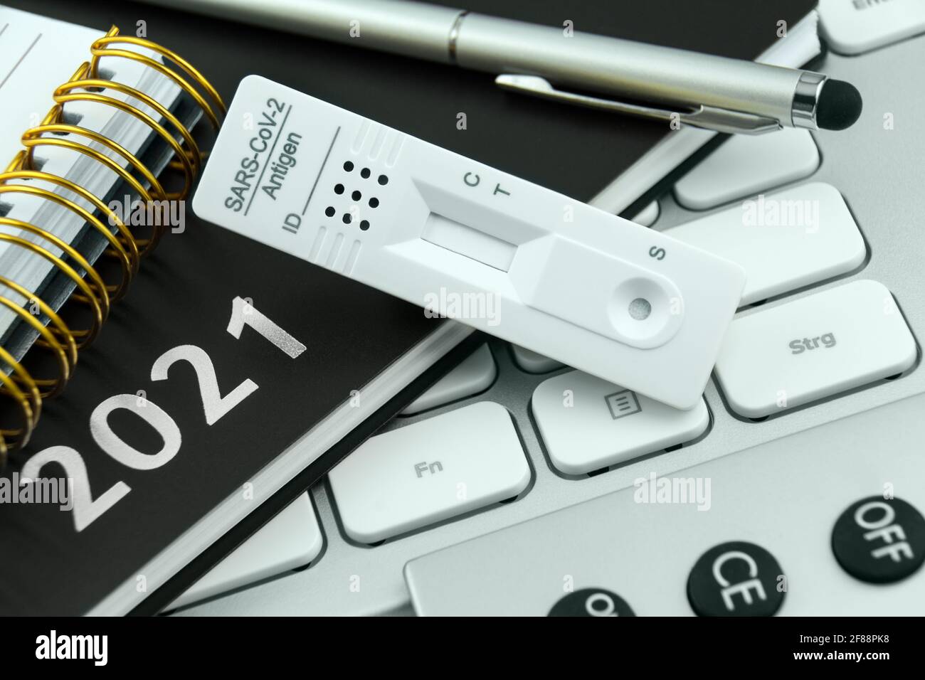 Corona Antigen Rapid Test and PC with calendar 2021 work station Stock Photo